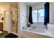 Elegant bathroom featuring a soaking tub and a glass-enclosed shower at 6052 Puesta Del Sol St, North Las Vegas, NV 89081