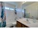 Bright bathroom featuring a tub with a shower and a decorative shower curtain at 6052 Puesta Del Sol St, North Las Vegas, NV 89081