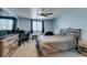 Spacious bedroom with a large bed, TV, desk and plenty of natural light at 6052 Puesta Del Sol St, North Las Vegas, NV 89081