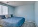 Blue bedroom with a cozy bed, offering a serene and calm atmosphere at 6052 Puesta Del Sol St, North Las Vegas, NV 89081