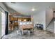 Dining room with open floor plan, wood-look tile floors and seamless access to a modern kitchen with bar seating at 6052 Puesta Del Sol St, North Las Vegas, NV 89081