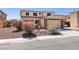 Charming two-story home with a tile roof, stone accents, and a well-manicured front yard at 6052 Puesta Del Sol St, North Las Vegas, NV 89081
