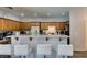 Charming kitchen features wood cabinets, breakfast bar with seating, and modern recessed lighting at 6052 Puesta Del Sol St, North Las Vegas, NV 89081