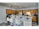 Modern kitchen featuring wood cabinets, a breakfast bar with seating, and stainless steel appliances at 6052 Puesta Del Sol St, North Las Vegas, NV 89081