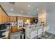 Charming kitchen features wood cabinets, breakfast bar with seating, and modern recessed lighting at 6052 Puesta Del Sol St, North Las Vegas, NV 89081