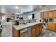 Open kitchen features wood cabinets, stainless steel dishwasher and spacious granite countertops at 6052 Puesta Del Sol St, North Las Vegas, NV 89081