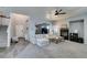Spacious living room with a fireplace, a ceiling fan, neutral walls, and ample natural light at 6052 Puesta Del Sol St, North Las Vegas, NV 89081