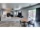 Open living and dining space with a fireplace, TV, and sliding glass doors to the outdoors at 6052 Puesta Del Sol St, North Las Vegas, NV 89081