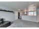 Spacious living room featuring gray carpet, neutral walls, and comfortable seating area at 6052 Puesta Del Sol St, North Las Vegas, NV 89081