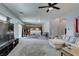 Open concept living room with plush seating, flat screen TV, and seamless flow into the dining and kitchen areas at 6052 Puesta Del Sol St, North Las Vegas, NV 89081