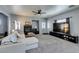 Spacious living room with a fireplace, a ceiling fan, neutral walls, and ample natural light at 6052 Puesta Del Sol St, North Las Vegas, NV 89081