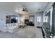 Spacious living room with a fireplace, a ceiling fan, neutral walls, and ample natural light at 6052 Puesta Del Sol St, North Las Vegas, NV 89081