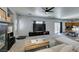 Spacious living room with a fireplace, a ceiling fan, neutral walls, and ample natural light at 6052 Puesta Del Sol St, North Las Vegas, NV 89081
