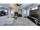 Spacious living room with a fireplace, a ceiling fan, neutral walls, and ample natural light at 6052 Puesta Del Sol St, North Las Vegas, NV 89081