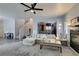 Spacious living room featuring a cozy fireplace, open stairs, and connecting to a workout area at 6052 Puesta Del Sol St, North Las Vegas, NV 89081