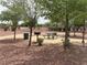 Park picnic area featuring a table, grill, and nearby trash receptacle, perfect for outdoor dining at 6052 Puesta Del Sol St, North Las Vegas, NV 89081