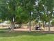 Neighborhood playground surrounded by mature trees, perfect for Gathering fun at 6052 Puesta Del Sol St, North Las Vegas, NV 89081