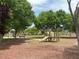 Community park featuring a playground with mature trees and walking paths at 6052 Puesta Del Sol St, North Las Vegas, NV 89081