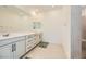Modern bathroom with double vanity, tile flooring, and a walk-in shower at 6607 Summershade St, North Las Vegas, NV 89086