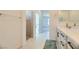 Spacious bathroom with double sinks, walk-in shower, and tiled floor at 6607 Summershade St, North Las Vegas, NV 89086