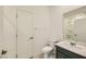 Well-lit bathroom with a modern vanity, toilet, and a large mirror reflecting the shower at 6607 Summershade St, North Las Vegas, NV 89086