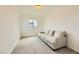 Cozy room with carpeted floors, a comfortable sofa, and natural light from a window overlooking the neighborhood at 6607 Summershade St, North Las Vegas, NV 89086