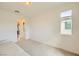 Bright room with carpeted floors, a comfortable sofa, and natural light from a window overlooking the neighborhood at 6607 Summershade St, North Las Vegas, NV 89086