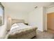Comfortable bedroom with a tufted headboard and carpet flooring at 6607 Summershade St, North Las Vegas, NV 89086