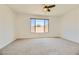 Spacious bedroom featuring a large window, carpet flooring and a ceiling fan at 6607 Summershade St, North Las Vegas, NV 89086