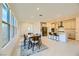 Open-concept dining area flowing into the kitchen, featuring modern table and chairs, perfect for entertaining at 6607 Summershade St, North Las Vegas, NV 89086