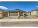 Charming single-story home featuring a well-manicured front yard and a two-car garage at 6607 Summershade St, North Las Vegas, NV 89086