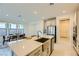 Modern kitchen featuring stainless steel appliances, large island with sink, and dining area with lots of natural light at 6607 Summershade St, North Las Vegas, NV 89086