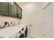 Convenient laundry room featuring modern washer and dryer units, plus ample cabinet space above at 6607 Summershade St, North Las Vegas, NV 89086