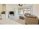 Cozy living room featuring neutral tones, plush seating, and a ceiling fan, offering a comfortable gathering space at 6607 Summershade St, North Las Vegas, NV 89086