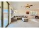 Spacious living room with large windows, a gray sectional sofa, and neutral decor, creating a relaxing ambiance at 6607 Summershade St, North Las Vegas, NV 89086