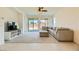Comfortable living room with carpet, large windows, and a patio slider at 6607 Summershade St, North Las Vegas, NV 89086