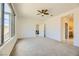 Large main bedroom with carpeted floors, ceiling fan, large window, and ensuite bathroom at 6607 Summershade St, North Las Vegas, NV 89086