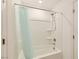 Bright and clean shower featuring a built-in showerhead, faucet, and recessed shelves for toiletries at 6607 Summershade St, North Las Vegas, NV 89086