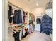Organized walk-in closet with shelving and hanging space for clothes and accessories at 6607 Summershade St, North Las Vegas, NV 89086