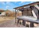 Enjoy this backyard hot tub with a shaded pergola, desert landscaping, and convenient bar seating at 7115 Calvert Cliffs St, North Las Vegas, NV 89084