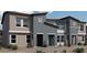 Modern townhouse with a stylish facade, featuring a neutral color scheme, well-manicured landscaping, and a welcoming entrance at 7375 Hayes Harbor Ct # Lot 210, North Las Vegas, NV 89084