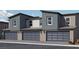 Stylish townhouse exteriors with gray garage doors, contemporary lighting, and well-maintained landscaping, enhancing curb appeal at 7375 Hayes Harbor Ct # Lot 210, North Las Vegas, NV 89084