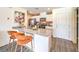 Stylish kitchen boasts white cabinets, a breakfast bar, and stainless steel appliances at 7375 Hayes Harbor Ct # Lot 210, North Las Vegas, NV 89084