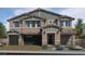 Inviting two-story home featuring a three-car garage and covered front entryway at 7709 Serenity Bay Ln # 56, North Las Vegas, NV 89084
