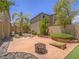 Spacious backyard with a concrete patio, fire pit, basketball hoop and mature landscaping at 8106 Eagle Clan Ct, Las Vegas, NV 89131