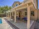 Covered backyard patio with outdoor seating, ceiling fans, and views of the backyard at 8106 Eagle Clan Ct, Las Vegas, NV 89131