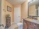 Well-lit bathroom with a decorative vanity, framed mirror, and tiled floors, offering a clean and functional space at 8106 Eagle Clan Ct, Las Vegas, NV 89131