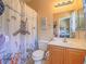 Bright bathroom featuring a single sink vanity, toilet and a playful shower curtain with sea animals at 8106 Eagle Clan Ct, Las Vegas, NV 89131