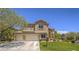 Charming two-story home with a three-car garage, well-manicured lawn, and mature landscaping at 8106 Eagle Clan Ct, Las Vegas, NV 89131