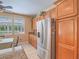 Bright kitchen featuring stainless steel refrigerator, wood cabinetry, and backyard views from breakfast nook at 8106 Eagle Clan Ct, Las Vegas, NV 89131